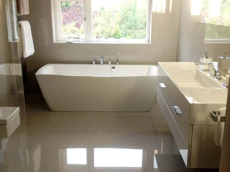 Talisien double ended bath beneath a window